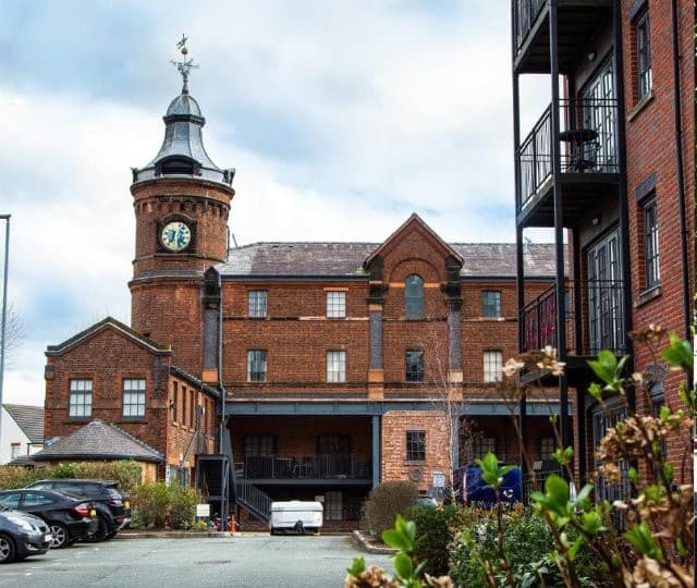 Restored mill development with clock tower
